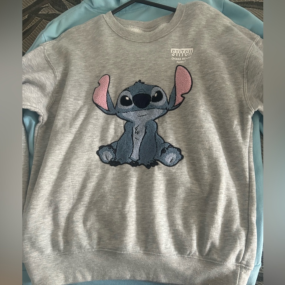 A Stitch sweater, is like brand new very cute for a trip or take to Disney.